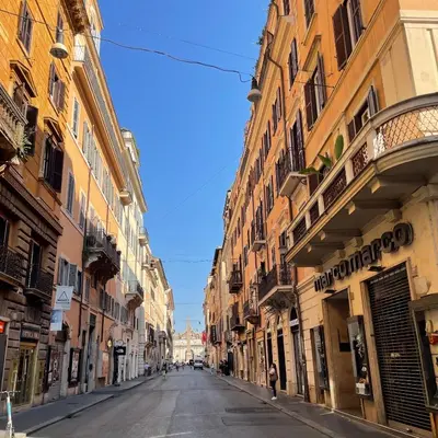 an empty street in a city with buildings at Civico43 in Rome