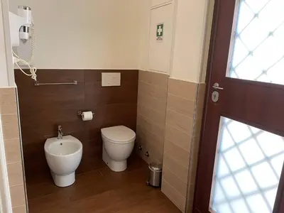 a small bathroom with a toilet and a sink at Civico43 in Rome
