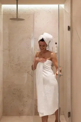 a woman in a white dress standing in a shower at Efes Hôtellerie in Rome
