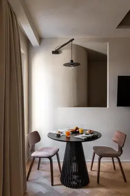a dining room with a table and chairs and a mirror at Efes Hôtellerie in Rome
