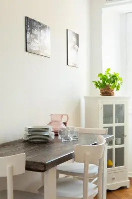 a dining room with a wooden table and white chairs at Pantheon Winning Position in Rome