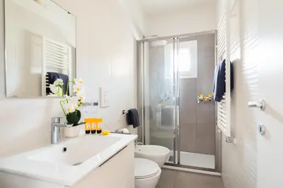 a white bathroom with a sink and a shower at Pantheon Winning Position in Rome
