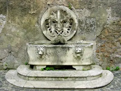 a stone fountain in front of a stone wall at Pantheon Winning Position in Rome