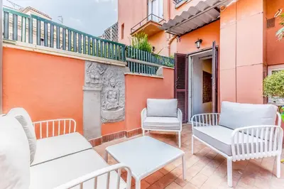 a patio with chairs and tables and a balcony at APT ROME Fratte di Trastevere in Rome