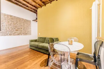 a living room with a green couch and a table at APT ROME Fratte di Trastevere in Rome