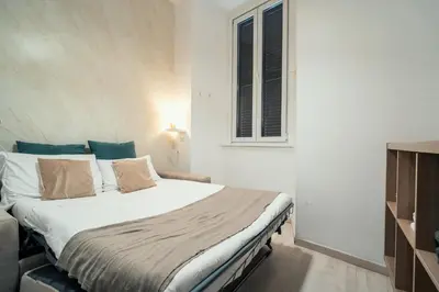 a bedroom with a bed and a window at Casa Mia Nazionale in Rome