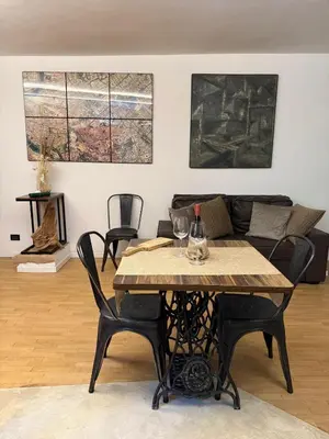 a living room with a table and a couch at Casa JULIA in Rome