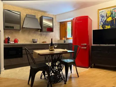 a kitchen with a red refrigerator and a table and chairs at Casa JULIA in Rome