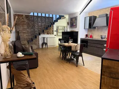 a kitchen and a living room with a table and chairs at Casa JULIA in Rome