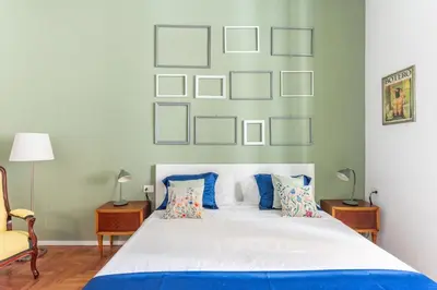 a bedroom with a large white bed with pictures on the wall at Elegance near Navona-for 5 guests in Rome