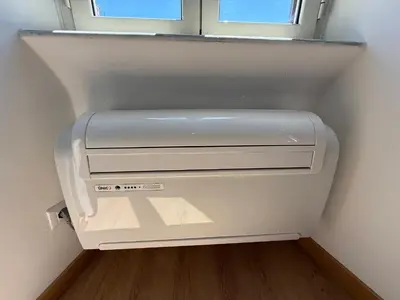 a white refrigerator in a room with a window at ETERNA Repubblica Apartment in Rome