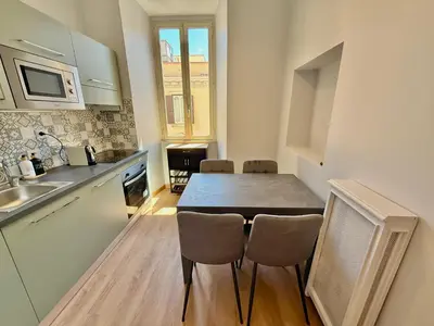 a kitchen with a table and chairs in a room at ETERNA Repubblica Apartment in Rome