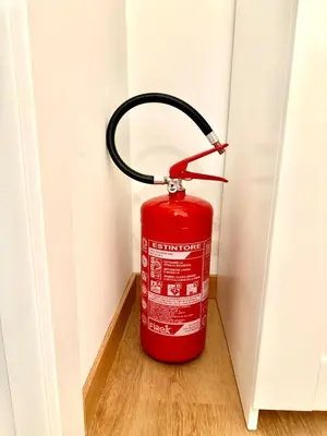 a red fire hydrant in a corner of a room at ETERNA Repubblica Apartment in Rome