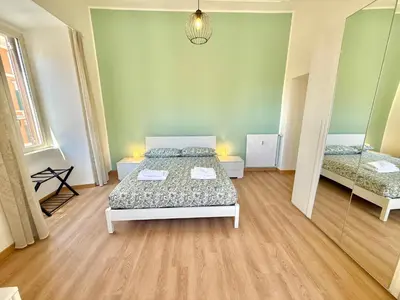 a large room with a bed and a mirror at ETERNA Repubblica Apartment in Rome