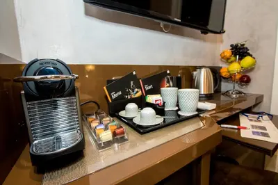 a counter with a coffee maker and cups on it at Vaticano Julia Guest House in Rome