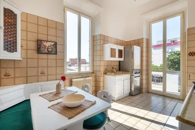 a kitchen with a table and some windows at Pigneto House - Residenze Romanae in Rome