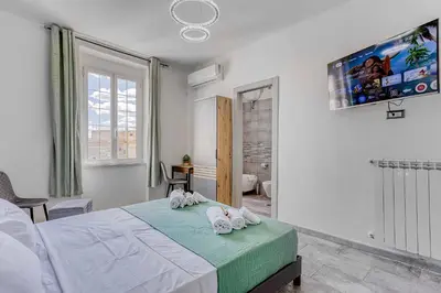 a bedroom with a bed with towels on it at ARDECORE VIA VIGEVANO Guest House o Affittacamere in Rome