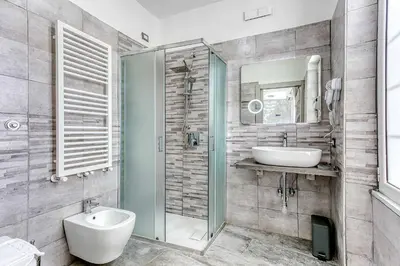 a bathroom with a toilet and a sink and a mirror at ARDECORE VIA VIGEVANO Guest House o Affittacamere in Rome
