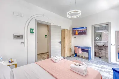 a bedroom with a bed and a bathroom with a sink at ARDECORE VIA VIGEVANO Guest House o Affittacamere in Rome