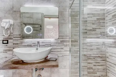 a bathroom with a sink and a shower at ARDECORE VIA VIGEVANO Guest House o Affittacamere in Rome