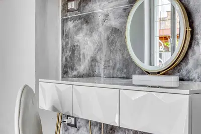 a bathroom with a white vanity with a round mirror at ARDECORE VIA VIGEVANO Guest House o Affittacamere in Rome