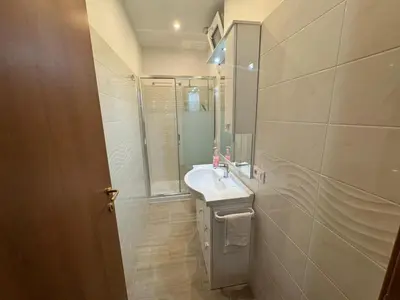 a bathroom with a sink and a shower and a mirror at B&B Kevin's Home in Rome