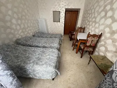 a bedroom with three beds and a table and chairs at B&B Kevin's Home in Rome