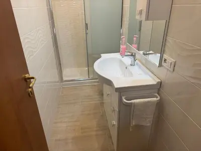 a bathroom with a sink and a shower at B&B Kevin's Home in Rome
