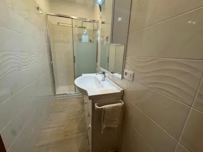 a bathroom with a sink and a mirror at B&B Kevin's Home in Rome