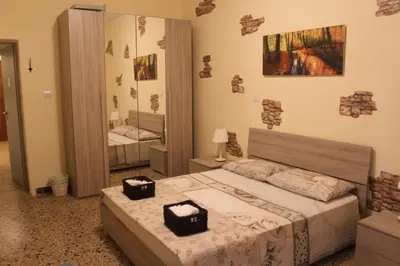 a bedroom with a bed and a large mirror at Da Giulia in Rome