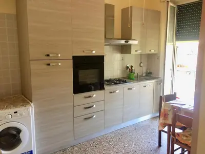a kitchen with a stove and a washing machine at Da Giulia in Rome