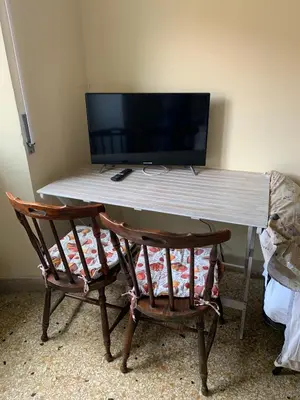 a desk with a computer monitor and two chairs at Da Giulia in Rome
