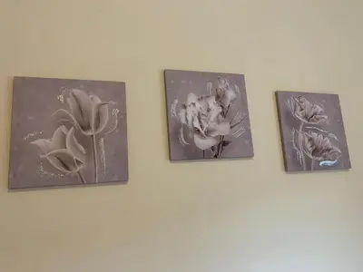 four pictures of flowers on a wall at Da Giulia in Rome