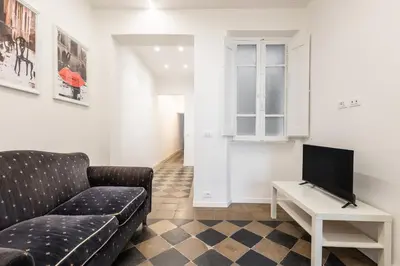 a living room with a couch and a tv at Top Location - walk to Navona Pantheon and Vatican in Rome