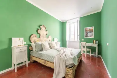a bedroom with green walls and a bed at Top Location - walk to Navona Pantheon and Vatican in Rome