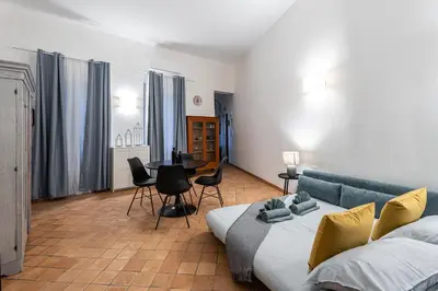 a living room with a couch and a table and chairs at Apartment AppiaAntica in Rome