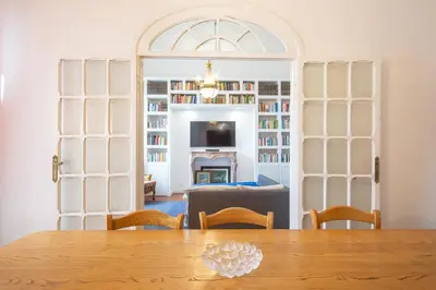 a dining room with a table and a living room with a fireplace at Suite Elizabeth in Barberini in Rome