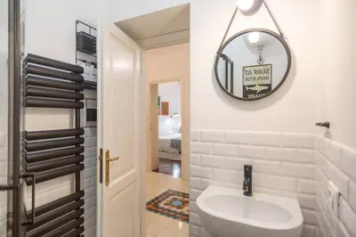 a bathroom with a white sink and a mirror at Suite Elizabeth in Barberini in Rome