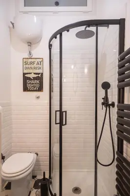 a bathroom with a shower with a toilet and a sign at Suite Elizabeth in Barberini in Rome