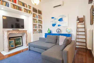 a living room with a couch and a fireplace at Suite Elizabeth in Barberini in Rome