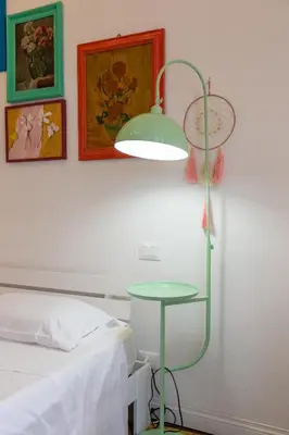 a bedroom with a bed and a lamp next to a table at Suite Elizabeth in Barberini in Rome
