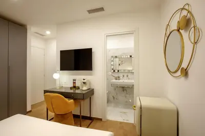 a small room with a desk and a mirror at Santaluna in Rome