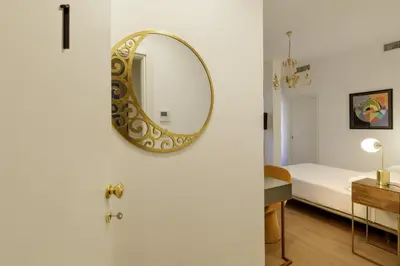 a mirror on a wall next to a bedroom at Santaluna in Rome