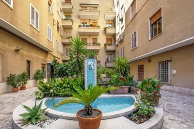 a courtyard with a swimming pool in front of a building at Santaluna in Rome