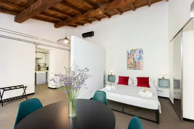 a bedroom with a bed and a table and chairs at Loft Ostiense Blue in Rome