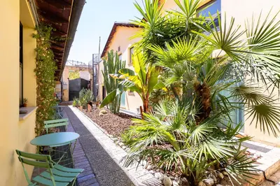 a courtyard with chairs and palm trees in a building at Loft Ostiense Blue in Rome