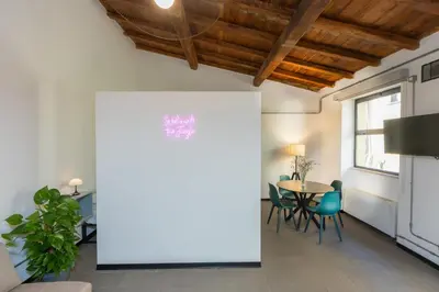 a living room with a table and chairs at Loft Ostiense Blue in Rome