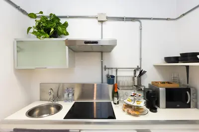 a kitchen counter with a sink and a microwave at Loft Ostiense Blue in Rome