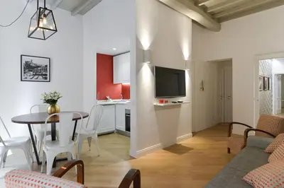 a living room and kitchen with a table and chairs at EVE Luxury Apartments Pantheon in Rome