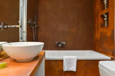 a bathroom with a large bowl sink and a tub at EVE Luxury Apartments Pantheon in Rome